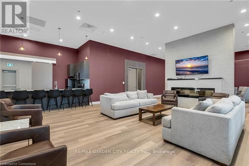 304 - 560 North Service Road, Grimsby, ON - Indoor Photo Showing Living Room With Fireplace