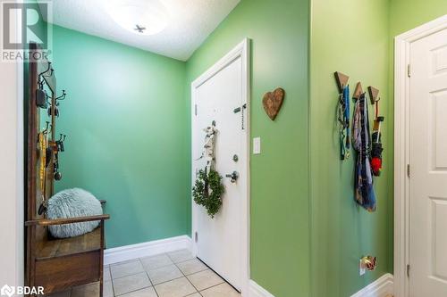 Foyer entrance with a textured ceiling and light tile patterned floors - 145 Farley Avenue Unit# 103, Belleville, ON - Indoor Photo Showing Other Room