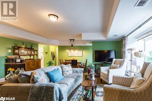 Living room with hardwood / wood-style floors and a textured ceiling - 145 Farley Avenue Unit# 103, Belleville, ON - Indoor Photo Showing Living Room