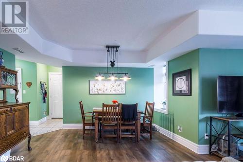 Dining space with wood-type flooring, a textured ceiling, and a raised ceiling - 145 Farley Avenue Unit# 103, Belleville, ON - Indoor Photo Showing Dining Room