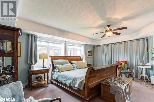 Carpeted bedroom featuring ceiling fan and a textured ceiling - 145 Farley Avenue Unit# 103, Belleville, ON - Indoor Photo Showing Bedroom