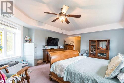 Carpeted bedroom featuring a tray ceiling and ceiling fan - 145 Farley Avenue Unit# 103, Belleville, ON - Indoor Photo Showing Bedroom