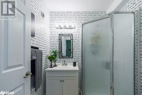 Bathroom featuring walk in shower, vanity, and tile walls - 145 Farley Avenue Unit# 103, Belleville, ON - Indoor Photo Showing Bathroom