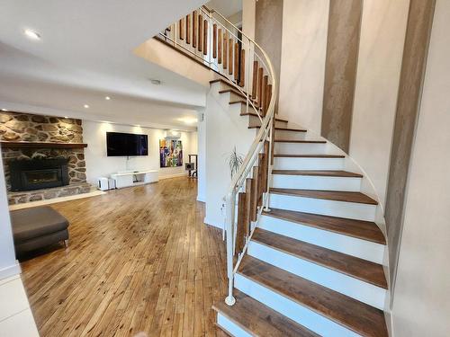 Escalier - 860 Rue Bazinet, Sainte-Thérèse, QC - Indoor Photo Showing Other Room With Fireplace