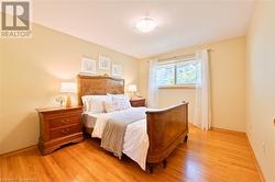 Large primary bedroom with hardwood floor - 