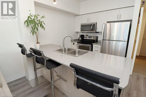 10 Concord Place Unit# 104, Grimsby, ON - Indoor Photo Showing Kitchen With Double Sink With Upgraded Kitchen