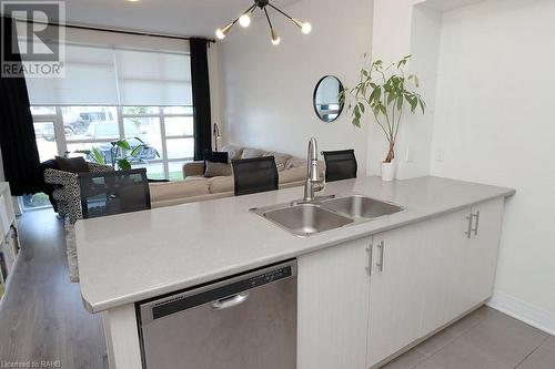 10 Concord Place Unit# 104, Grimsby, ON - Indoor Photo Showing Kitchen With Double Sink