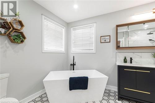 relaxing soaker tub - 54 Stonepine Crescent, Hamilton, ON - Indoor Photo Showing Bathroom