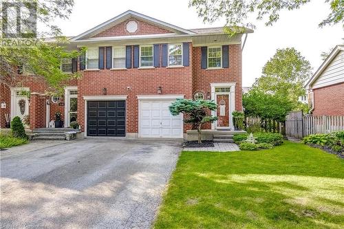 Street view. End unit with tasteful landscaping and driveway 3 cars long - 2141 Ghent Avenue, Burlington, ON - Outdoor With Facade