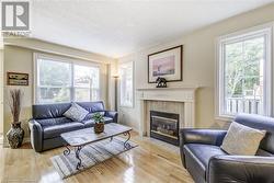 living room with N/gas fireplace,  hardwood flooring - 