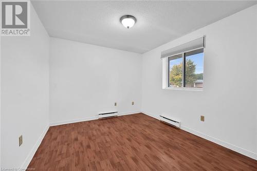 Primary bedroom with window overlooking balcony - 482 James Street N Unit# 203, Hamilton, ON - Indoor Photo Showing Other Room