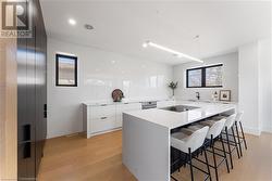 Kitchen. Quartz countertops. Thermador microwave fridge and freezer are hidden in black cabinetry to the left. - 