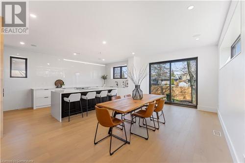 Dining area and kitchen. Sliding doors to glass stairway which leads to private patio. - 5427 Anthony Place, Burlington, ON - Indoor