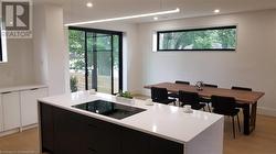 View of eating area and door to side garden. Privacy windows. White oak flooring - 