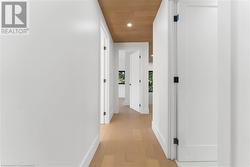 Upper hallway. Pot lighting. White oak flooring and ceiling. 9 foot ceilings. - 