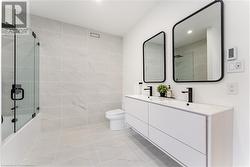 Main bathroom. Double sinks. Tub with rainhead shower, handspray. Pull out drawers. Heated floors. - 