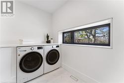 Laundry within spacious main bathroom. Heated floor. - 