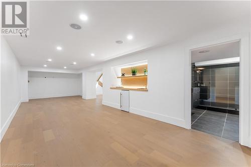 Lower level Family Room. Wet bar, bar fridge, ambient lighting on oak shelving. Spacious 3 piece bathroom. - 5427 Anthony Place, Burlington, ON - Indoor Photo Showing Other Room