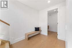 Mudroom. Built in bench. 2 huge double closets on right wall. Washroom. Glass stairway to upper level. - 