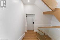 Stairway down to side door and lower level. White oak and glass. - 