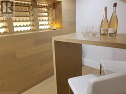 Wine Bar. Backlit wine rack, built-in table, white oak wall and flooring. - 