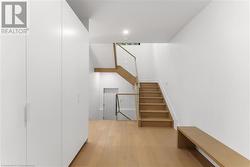 Mudroom. Floating bench. View from 2 pc to upstairs & side door. 2 Large double closets with lower pull-outs. - 