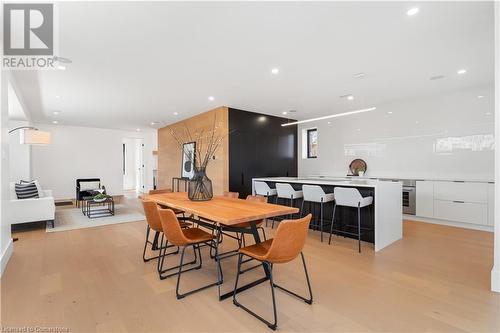 Open concept kitchen, dining, living. White oak flooring and feature wall. Speakers, pot lighting. - 5427 Anthony Place, Burlington, ON - Indoor Photo Showing Other Room