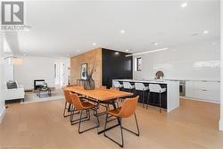 Open concept kitchen, dining, living. White oak flooring and feature wall. Speakers, pot lighting. - 