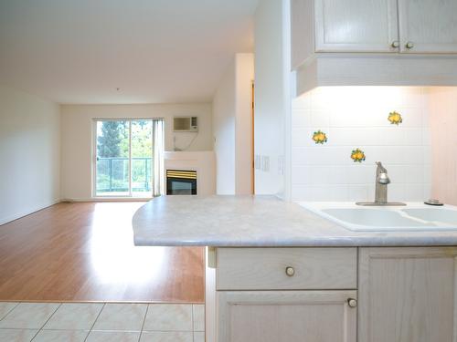 110-3221 Centennial Drive, Vernon, BC - Indoor Photo Showing Kitchen With Fireplace