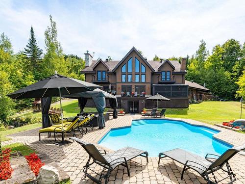 Face arriÃ¨re - 4855 Ch. Du Lac-Théodore, Morin-Heights, QC - Outdoor With In Ground Pool With Deck Patio Veranda