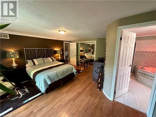 Master bedroom with his and hers closet and walk-in closet,  5 piece en-suite w/Jacuzzi tub and shower - 16 Flamingo Drive, Hamilton, ON - Indoor Photo Showing Bedroom