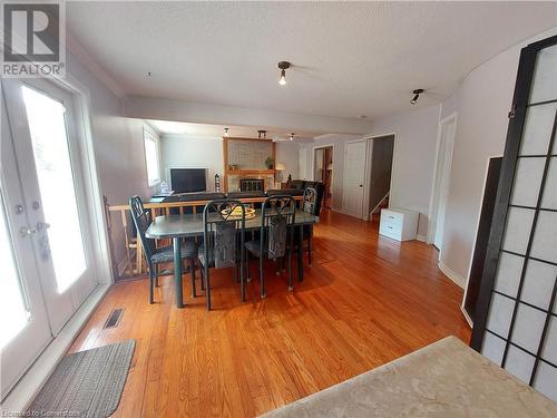 Lower 3rd level Dining room and Family room with cozy wood burning fire place and a walk out to your back yard oasis perfect for entertaining or just relaxing - 16 Flamingo Drive, Hamilton, ON - Indoor Photo Showing Dining Room