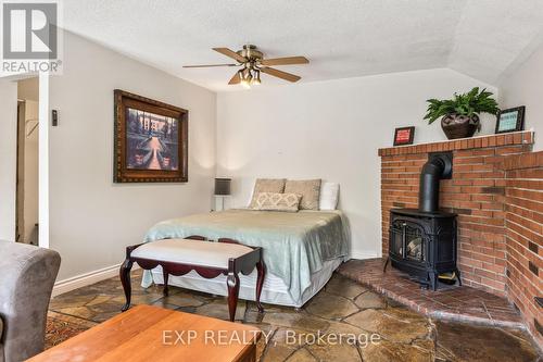 B - 11532 Longwoods Road, Middlesex Centre (Delaware Town), ON - Indoor Photo Showing Bedroom With Fireplace