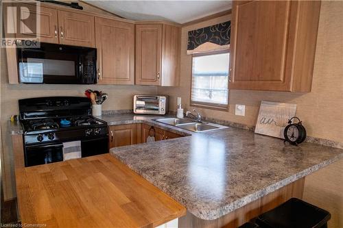 1501 Line 8 Road Unit# 142, Niagara-On-The-Lake, ON - Indoor Photo Showing Kitchen With Double Sink