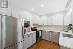 Kitchen with quartz counter tops and stainless steel appliances - 