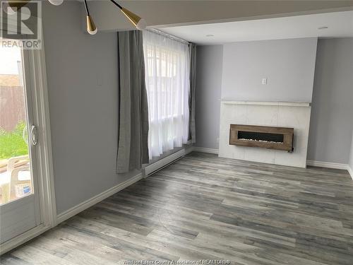 8324 Gregory Place, Windsor, ON - Indoor Photo Showing Living Room With Fireplace