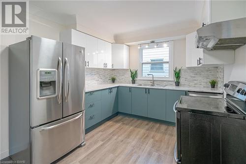 Brand new kitchen in main floor unit features stainless steel fridge, stove, hood vent and dishwasher. - 19 Fawell Avenue, St. Catharines, ON - Indoor Photo Showing Kitchen