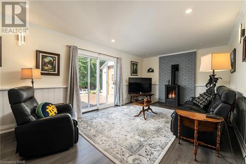 family room with glass doors leading to backyard/deck - 5 Lower Canada Drive, Niagara-On-The-Lake, ON - Indoor Photo Showing Living Room With Fireplace