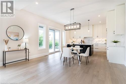 Modern space and lights - 1 West Avenue, Stoney Creek, ON - Indoor Photo Showing Dining Room