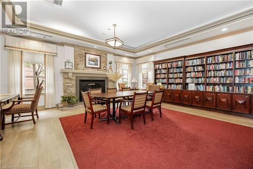 100 Burloak Drive Unit# 1214, Burlington, ON - Indoor Photo Showing Dining Room With Fireplace