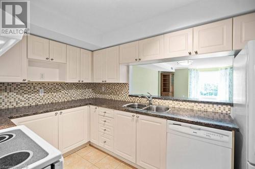 Generous sized kitchen with loads of cabinets and counter space! - 216 Plains Road W Unit# D307, Burlington, ON - Indoor Photo Showing Kitchen With Double Sink