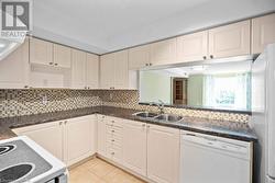 Generous sized kitchen with loads of cabinets and counter space! - 