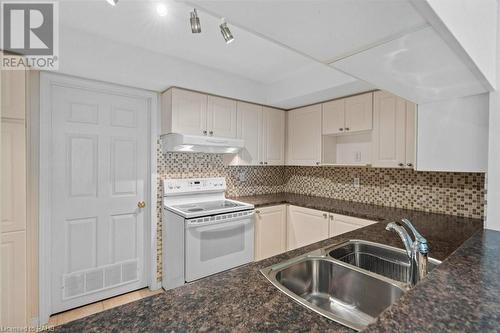 Laundry/utility right off of kitchen! - 216 Plains Road W Unit# D307, Burlington, ON - Indoor Photo Showing Kitchen With Double Sink