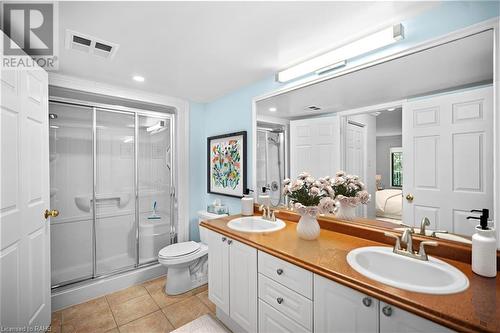 Large bathroom with double sinks and an updated walk-in shower! - 216 Plains Road W Unit# D307, Burlington, ON - Indoor Photo Showing Bathroom