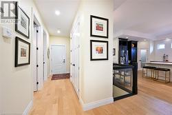 Hall Leading to Oversized 2.5 Car Garage with Epoxy Flooring and Rear Yard Access - 