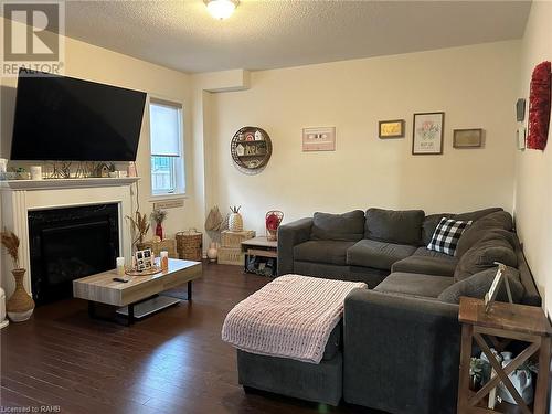 Family room with gas fireplace & hardwood flooring - 37 Homestead Way Unit# Upper, Thorold, ON - Indoor Photo Showing Living Room With Fireplace