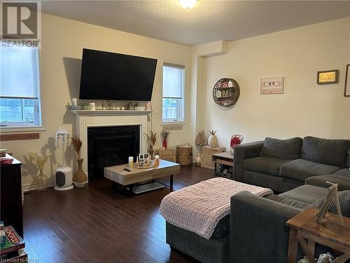 Family room with gas fireplace & hardwood flooring - 37 Homestead Way Unit# Upper, Thorold, ON - Indoor Photo Showing Living Room With Fireplace