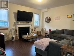 Family room with gas fireplace & hardwood flooring - 