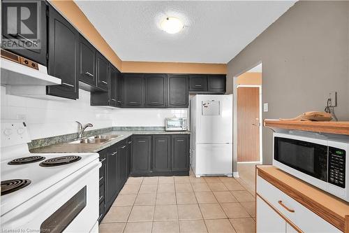 2301 Derry Road W Unit# 1005, Mississauga, ON - Indoor Photo Showing Kitchen With Double Sink