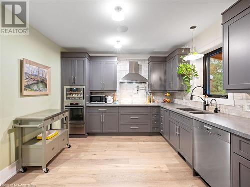 Kitchen in upper unit (2nd flr). Soft close cabinetry including hidden garbage/recycling and designated spice drawer! - 213 Caroline Street S, Hamilton, ON 